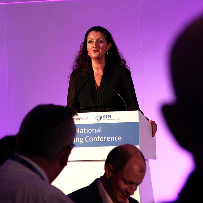 Speaker at National Planning Conference stood at a podium on a stage